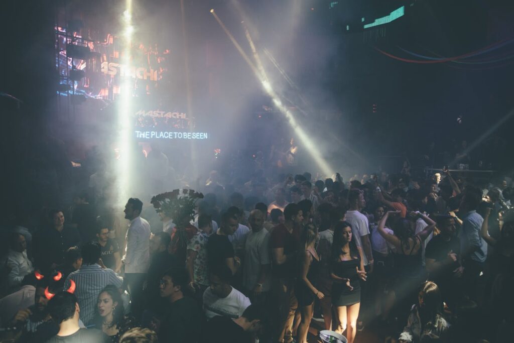 Exciting nightclub scene with a dancing crowd, vibrant lights, and music atmosphere.
